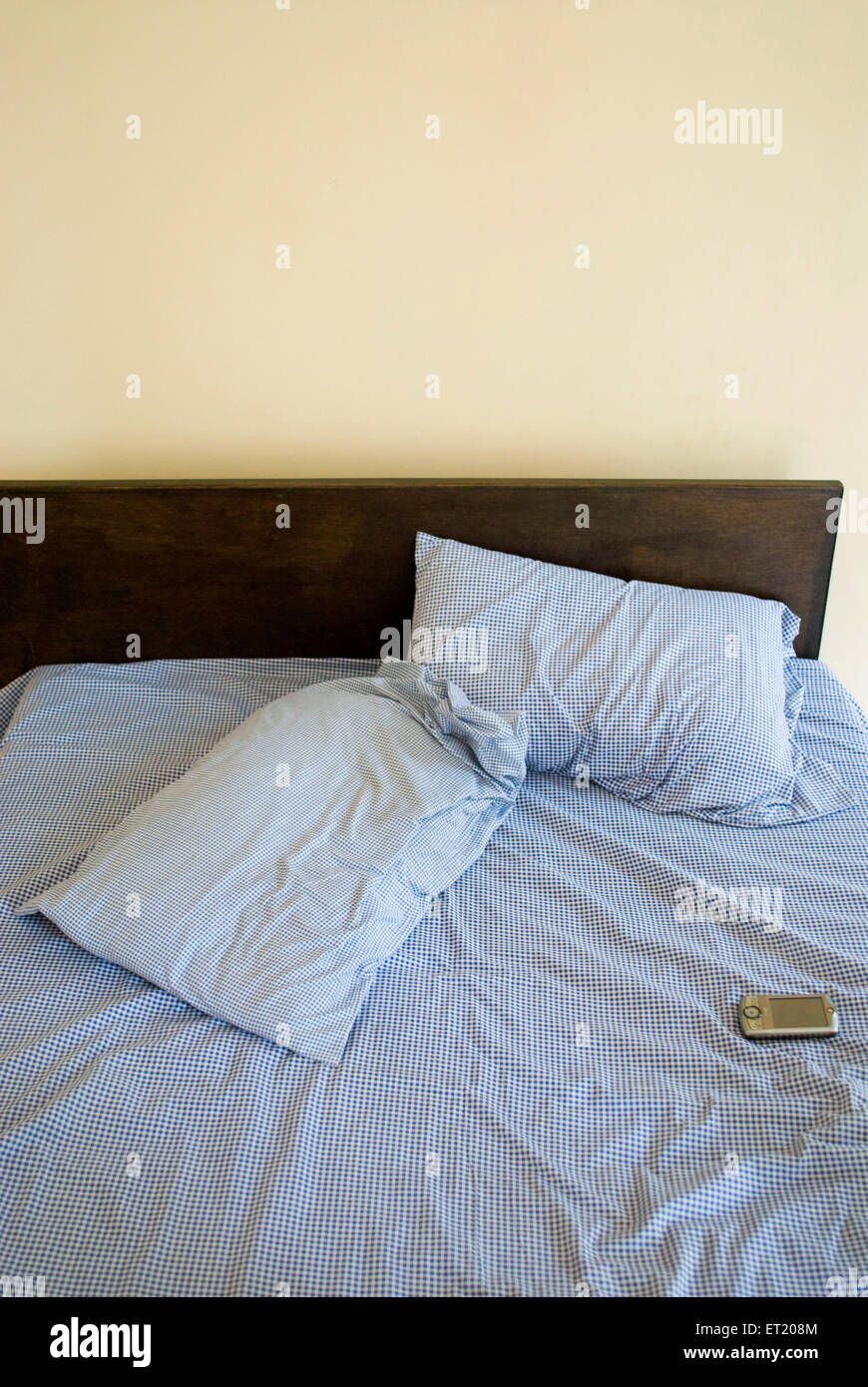 Pillows on bed with mobile phone, Panjim, Panaji, Goa, India, Asia Stock Photo