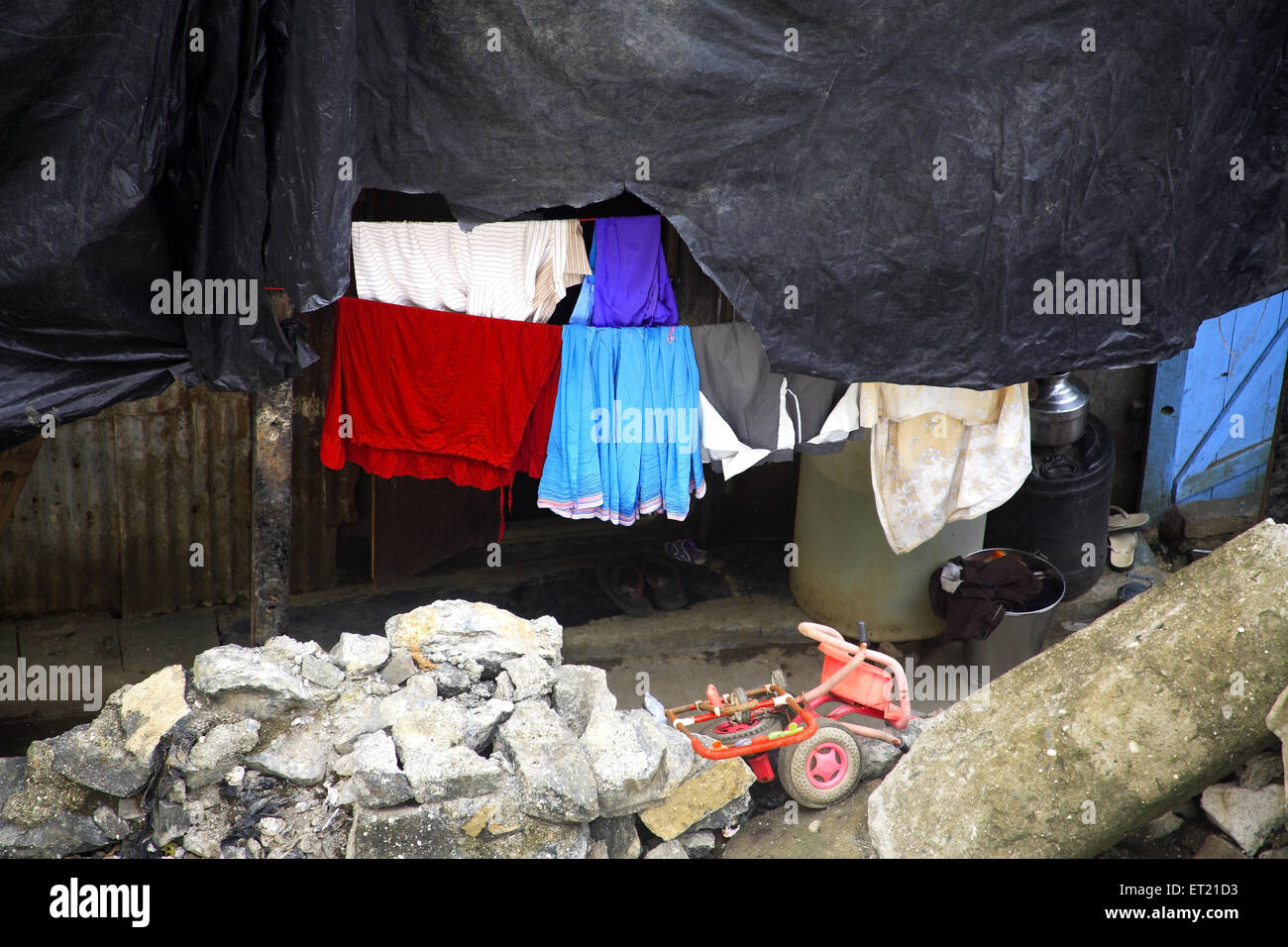 Plastic sheet drying cloth and debris in slum ; Behram Naupada ; Anant Kanekar Marg ; Bandra ; Bombay Mumbai ; Maharashtra Stock Photo