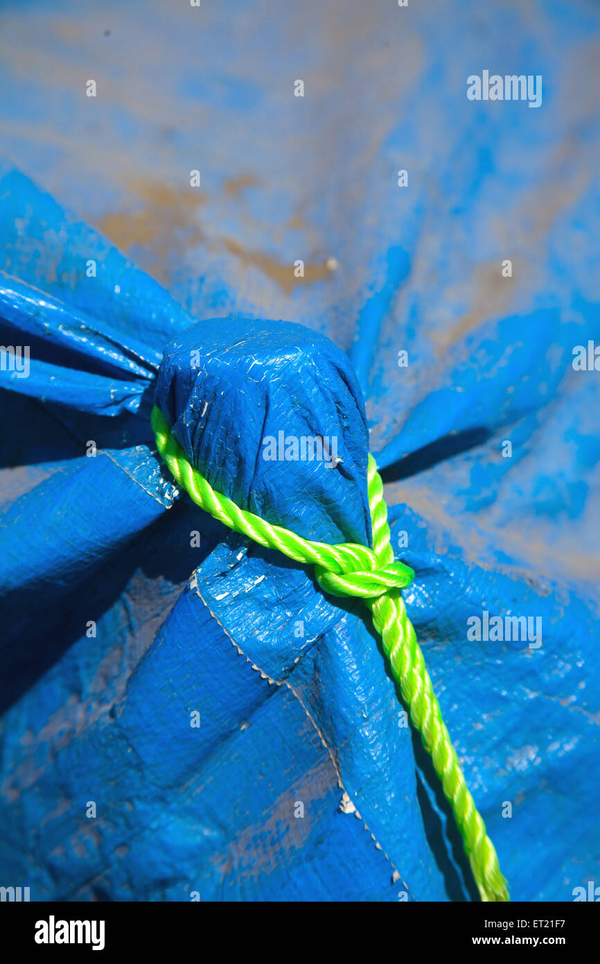 Nylon green thread knot on blue plastic Stock Photo
