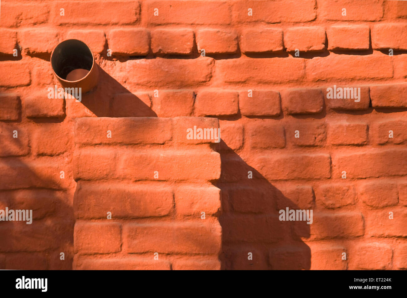 brick wall pipe ; Pune ; Maharashtra ; India ; Asia Stock Photo
