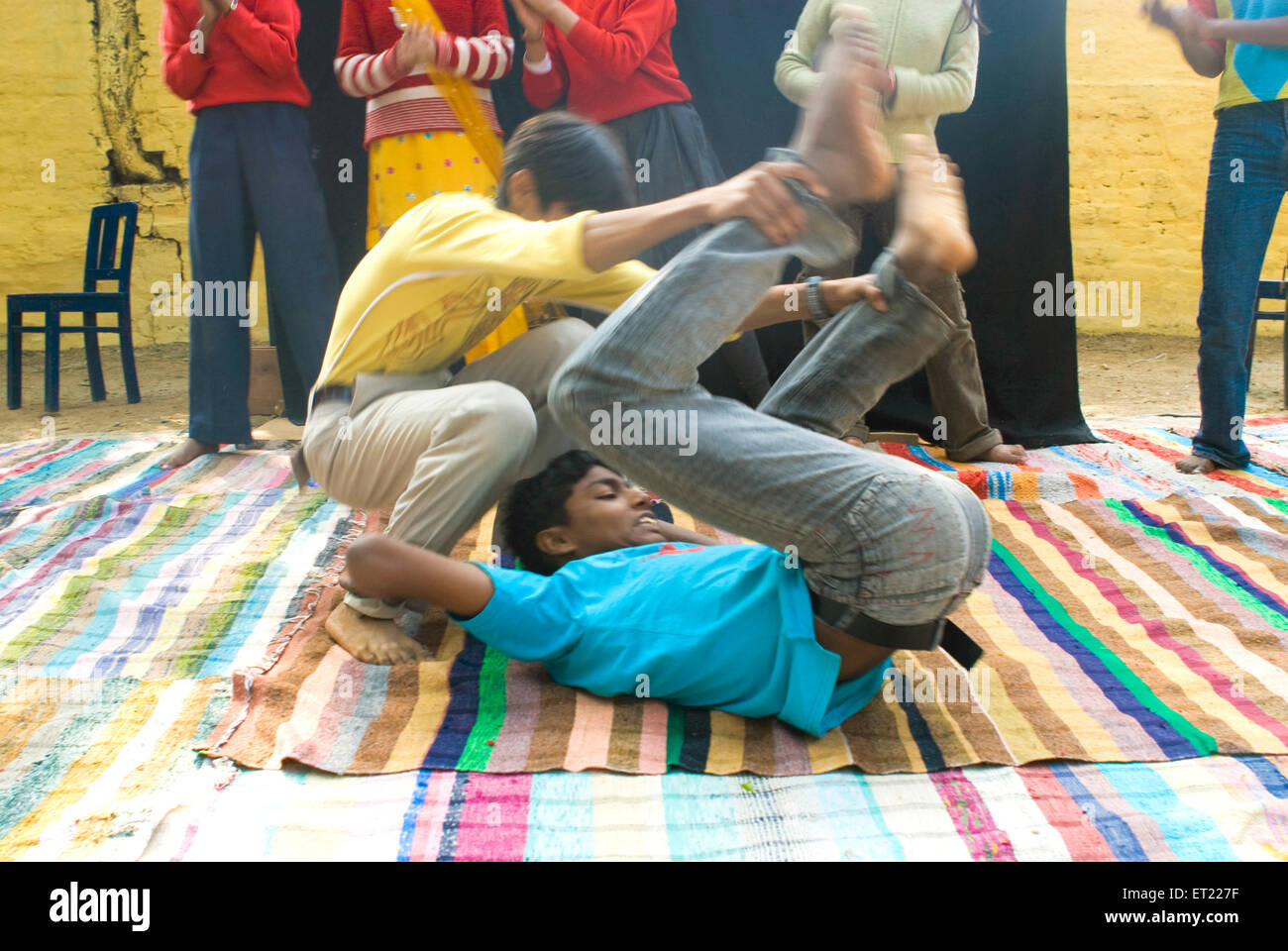 Boys doing human cartwheel part of acrobat circus performance in Nanhi Duniya school ; Dehra Dun ; Uttaranchal Uttarakhand Stock Photo