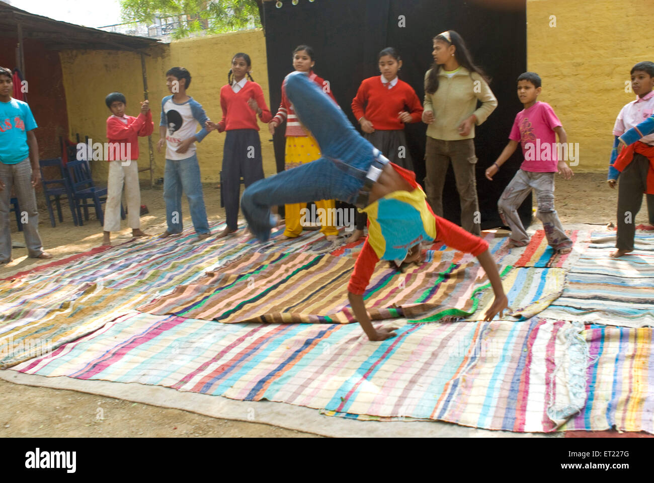 Boys doing human cartwheel part of acrobat circus performance in Nanhi Duniya school ; Dehra Dun ; Uttaranchal Uttarakhand Stock Photo