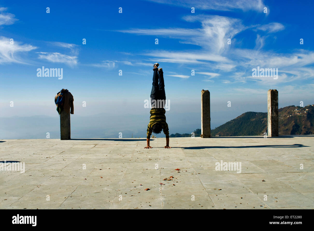 Indian acrobat doing handstand act ; Mussoorie ; Dehra Dun ; Uttaranchal Uttarakhand ; India MR#711 Stock Photo