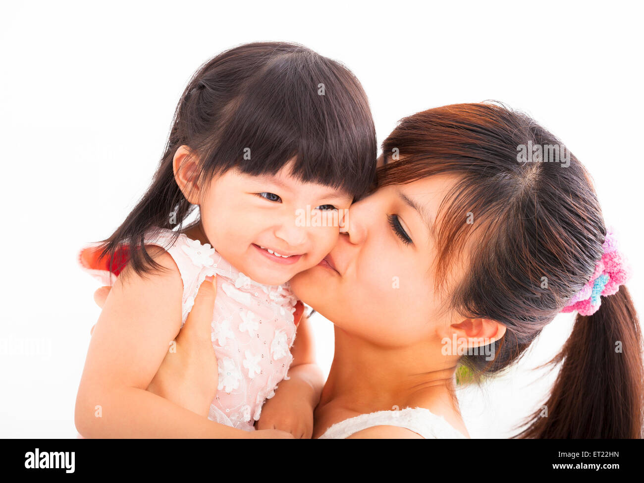 happy Mother kissing her daughter Stock Photo