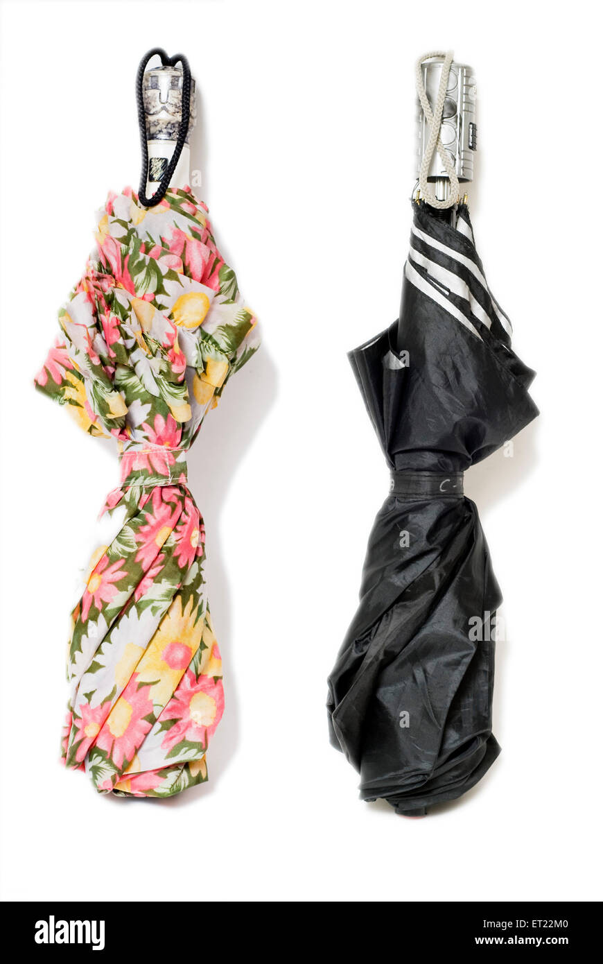 One ladies umbrella with floral pattern and black umbrella for men ; Mulund ; Bombay ; Mumbai ; Maharashtra ; India ; Asia Stock Photo