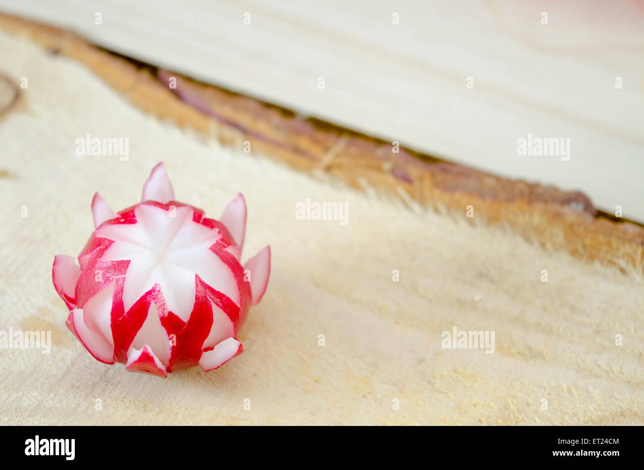 Decorated red radish on a rough wooden surface Stock Photo