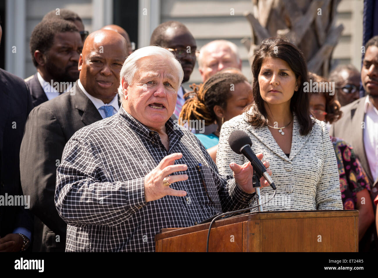 North Charleston Mayor Keith Summey speaks at a signing ceremony for the first bill in the nation requiring all police to wear video cameras as Governor Nikki Haley looks on June 10, 2015 in North Charleston, South Carolina. The bill was a result of the killing of Walter Scott by a police officer in North Charleston in April. Stock Photo