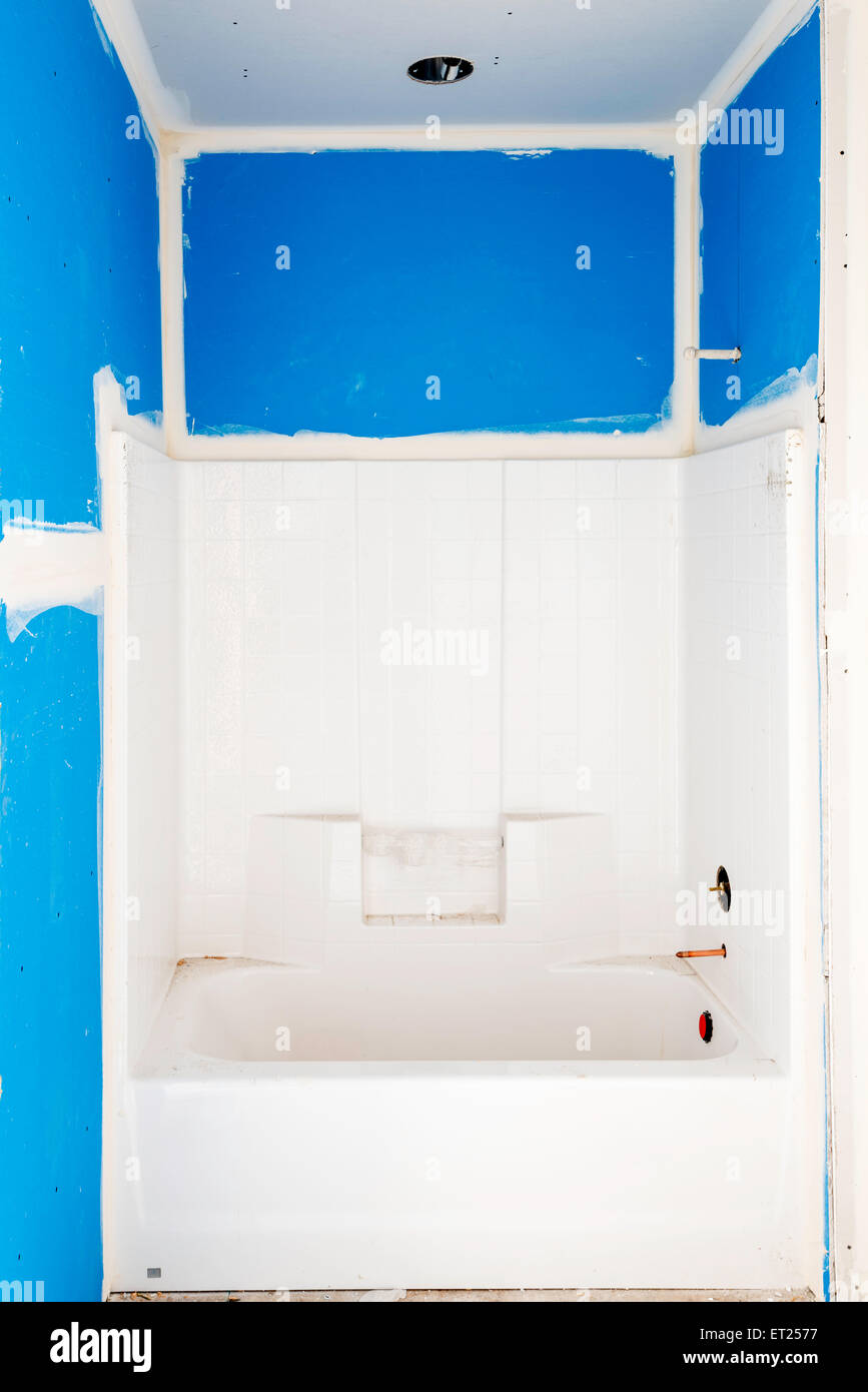 Bathtub install in new home construction Stock Photo Alamy