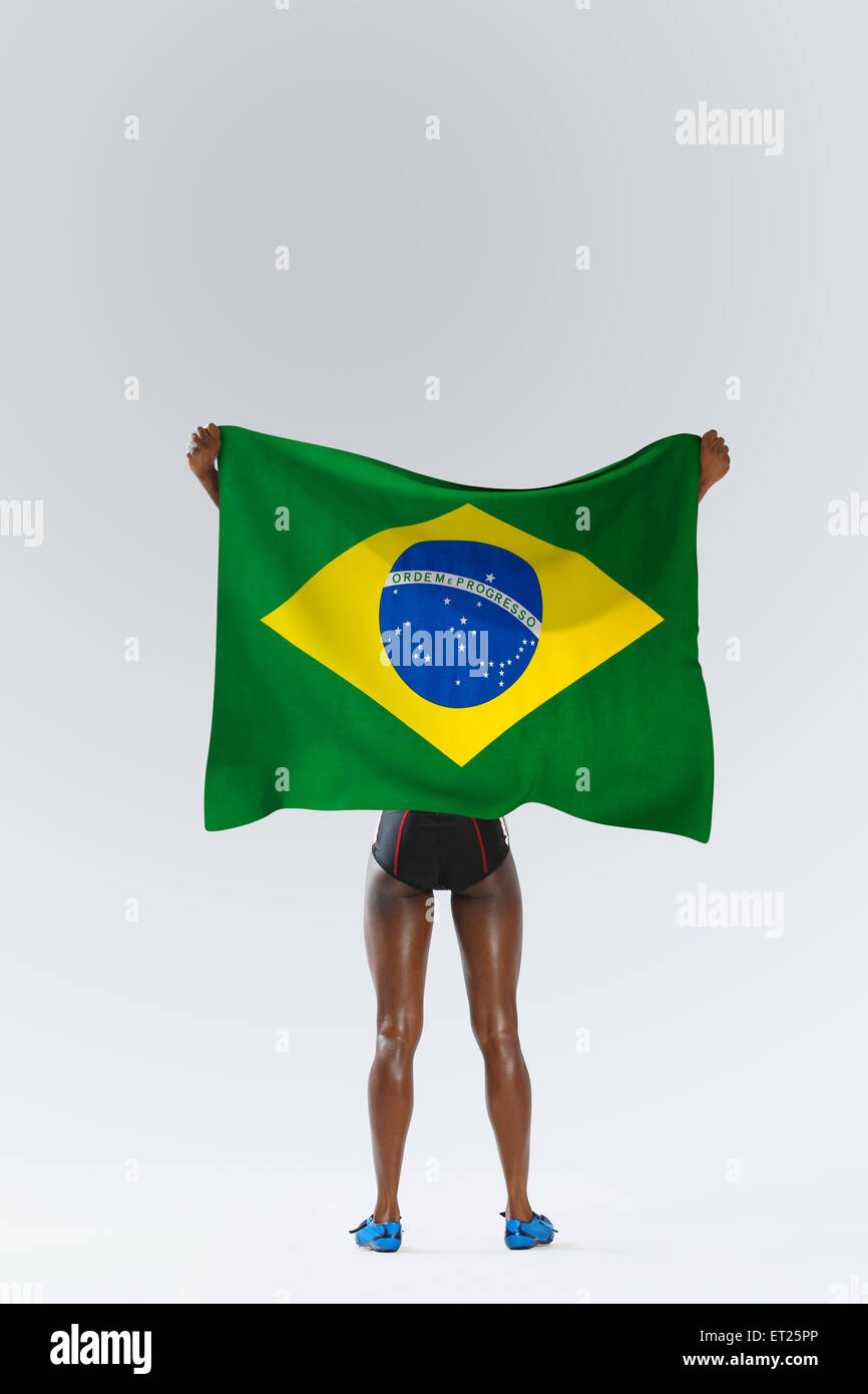 Female Athlete Holding a Brazilian Flag Stock Photo