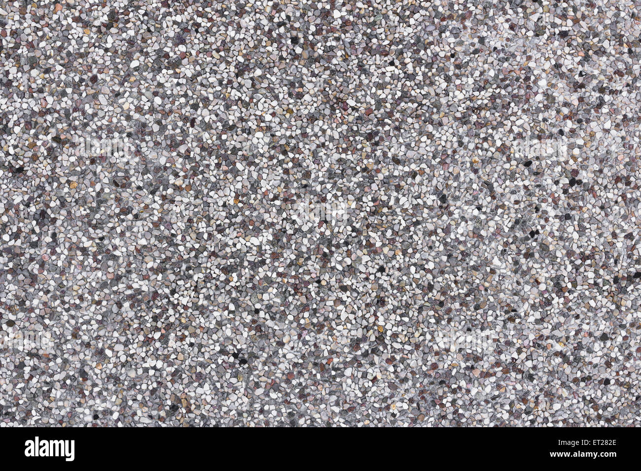 Backdrop composed of tiny white pebbles, grays and browns. Stock Photo