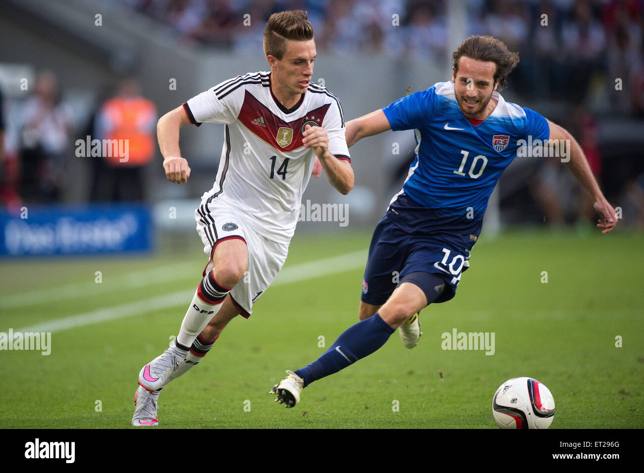 Cologne, Germany. 10th June, 2015. Germany's Patrick Herrmann (L) and the USA's vie for the ball Mix Diskerud during the international soccer match between Germany and the USA in the RheinEnergie Stadium in Cologne, Germany, 10 June 2015. Photo: Marius Becker/dpa/Alamy Live News Stock Photo