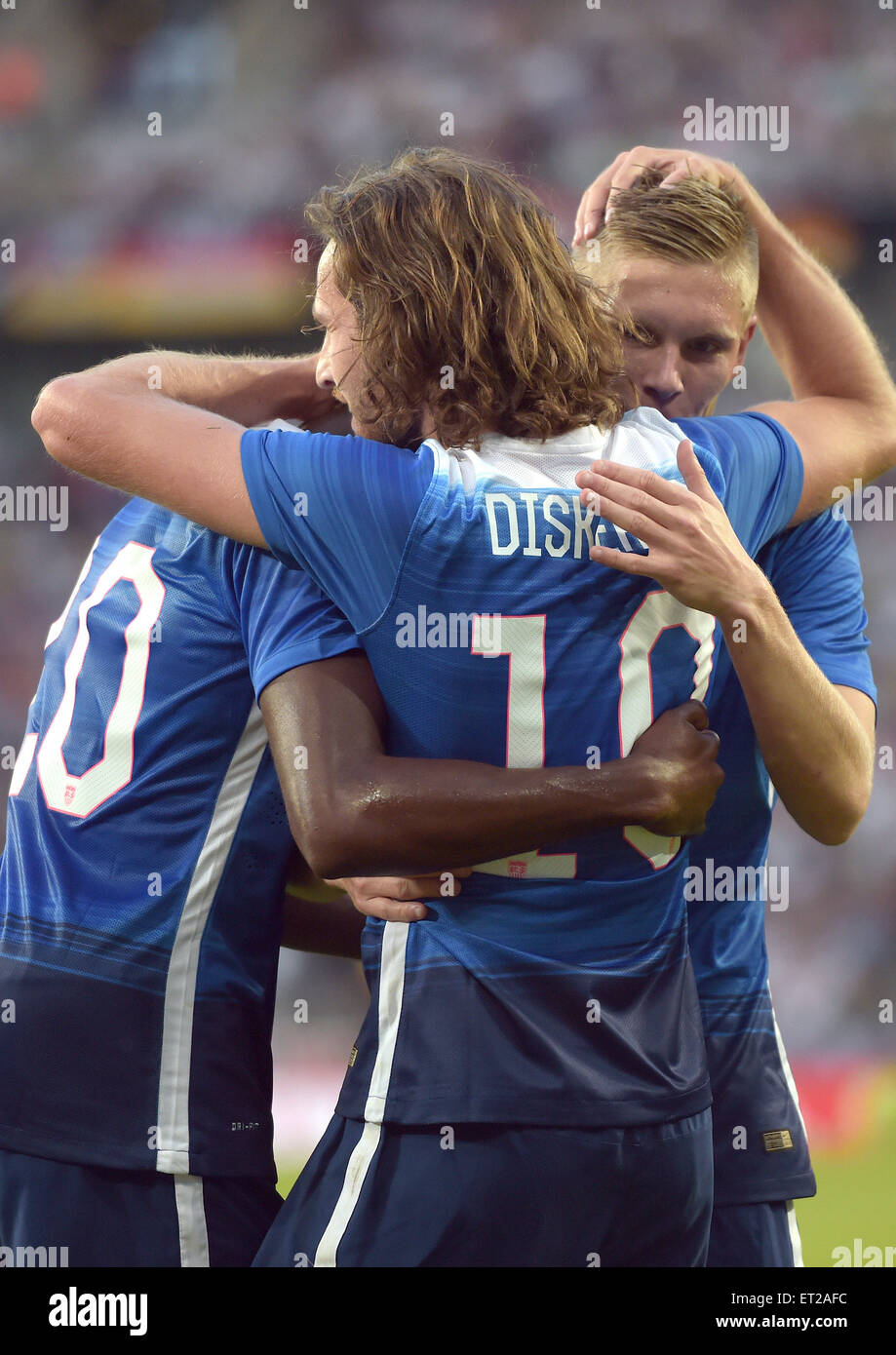 Cologne, Germany. 10th June, 2015. USA's goal scorer Mix Diskerud celebrates his 1-1 goal with Gyasi Zardes (L) and Aron Johannsson during the international soccer match between Germany and the USA in the RheinEnergie Stadium in Cologne, Germany, 10 June 2015. Photo: Federico Gambarini/dpa/Alamy Live News Stock Photo