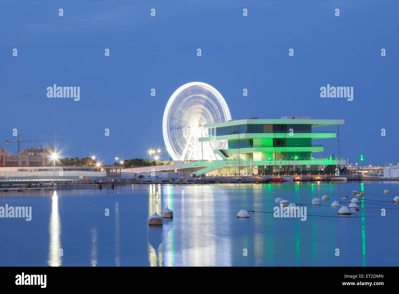 Americas Cup building and Ferris Wheel in the port of Valencia illuminated at night Stock Photo