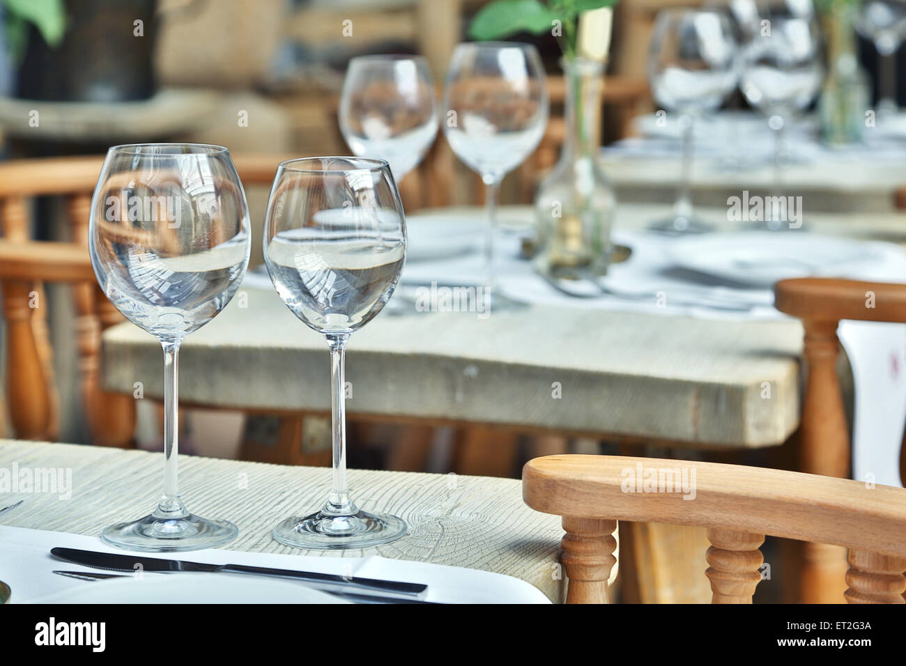 Table setting with wine glasses at the vintage cafe. Stock Photo