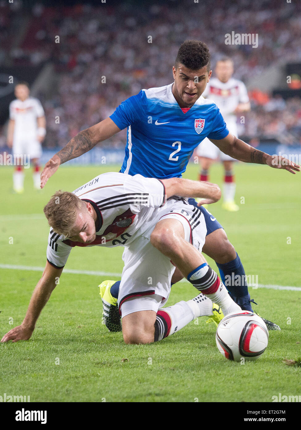 Cologne, Germany. 10th June, 2015. Germany's Christoph Kramer (BELOW) and the USA's und DeAndre Yedlin in action during the international soccer match between Germany and the USA in the RheinEnergie Stadium in Cologne, Germany, 10 June 2015. Photo: Marius Becker/dpa/Alamy Live News Stock Photo