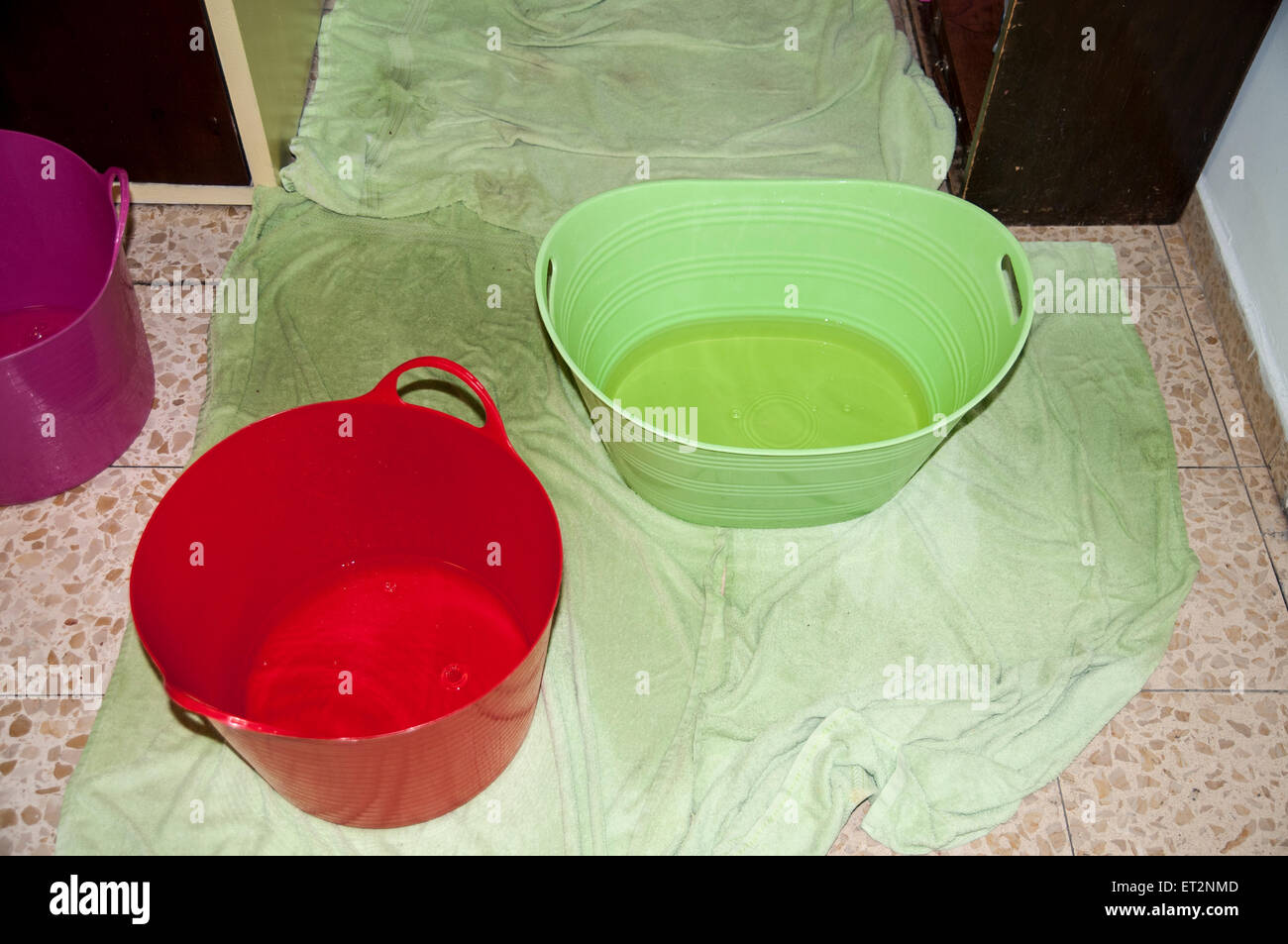Rain Water Is Collected In Buckets And Pails As It Leaks