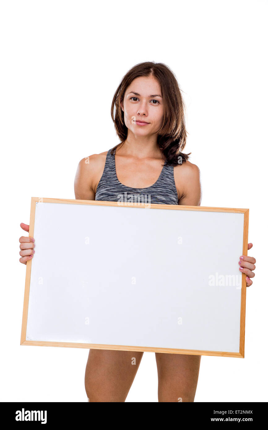 female bodybuilder holds a blank whiteboard ready for your own message Model release available Stock Photo