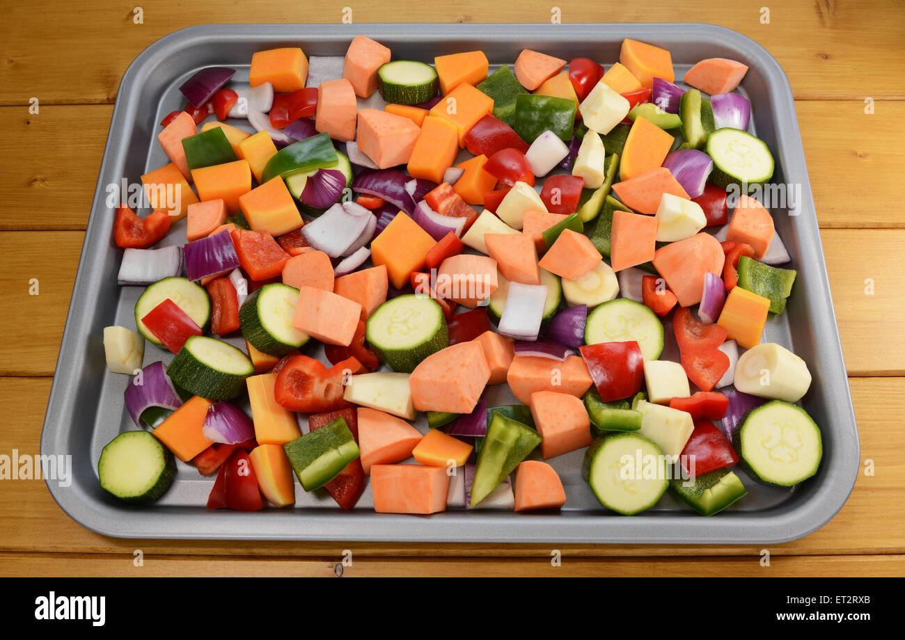 Chopped raw vegetables - red onion, butternut squash, red pepper, courgette, parsnip, green pepper, sweet potato Stock Photo