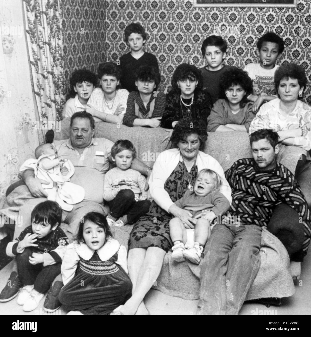 The Attard Family, 3rd February 1987. The family of 17, 7 adults and 10 children, live together in a four bedroom council house on the Trowbridge Estate in Cardiff. The family, grand parents Charlie 51 and Jenny Attard, 10 of their children and 5 grandchildren have chosen to live together for the last few years. Pictured, Charlie and Jenny, with daughter Evelyn Davies 31 and her children Nadia 5, Omar 4, daughter Connie Bugeja 26 and children Danny 4 and Anton 3 months, daughters Stella 22, who is 8 months pregnant, Anna 19, Odette 17 and Susan 12 and sons Edmund 23, Joseph 15, Gareth & David Stock Photo