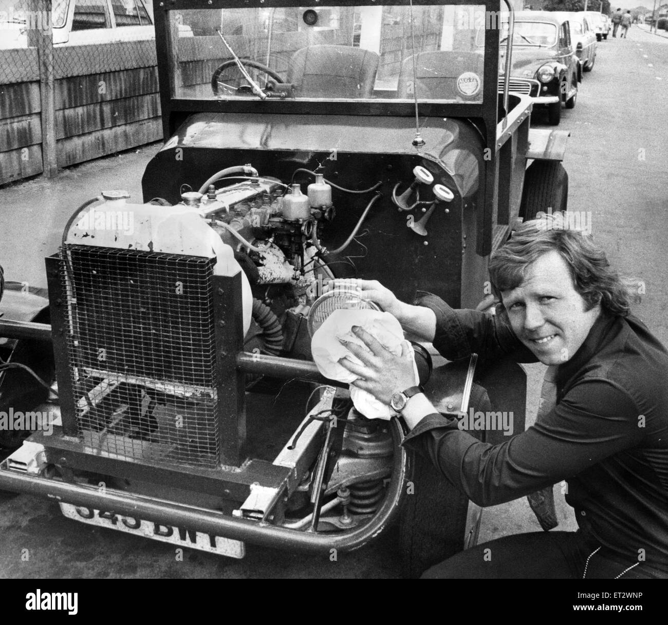 A Hot Rod Buggy, or technically, a Bedford chassis with an Austin three litre engine, currently on sale at R and H Car Sales on Cumberland Road for 350 pounds. Pictured, salesman Stephen Billan gives the car a polish, 8th June 1972. Stock Photo