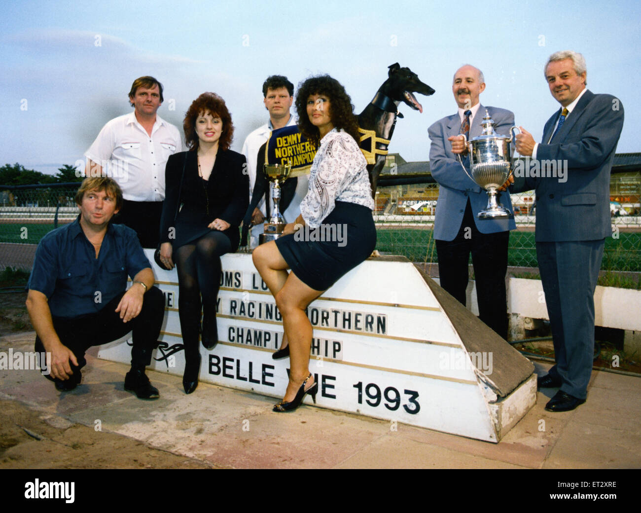 Norman Johnson receives the Demmy Racing Northern Flat Championship trophy from the sponsor's managing director Ken johnston with Mick Bacon, Tony Bacon, kennelhand Andrew Hayes, Lisa Hayes and Stella Leonard looking on at Belle Vue greyhound stadium. Jul Stock Photo