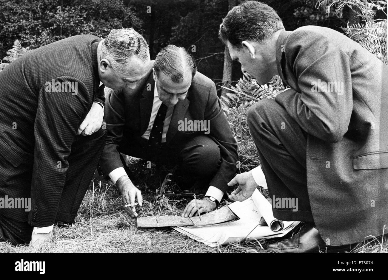 Assistant Chief Constable S E Bailey, Det. Chief Supt. H Bailey and Det. Insp. Fernihough study aerial pictures with a stereoscopic viewer amongst the ferns on Cannock Chase. The Cannock Chase murders (also known as the A34 murders) were the murders of th Stock Photo