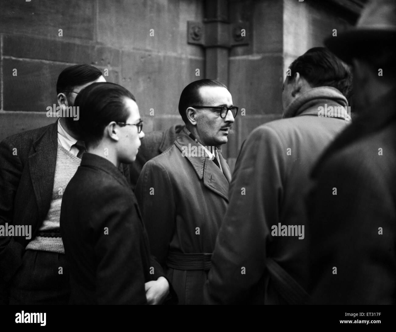 Carlo Mogano, husband of Penelope Mogano found murdered in her home, waiting outside Coventry Police Station today as detectives continued their search for her murderer. 20th January 1954. Stock Photo