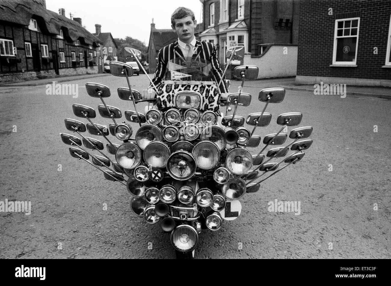 School leaver Bryn Owen aged 17 with his Vespa scooter, which has 34 mirrors and 81 lights on the front and back, all bought with his pocket money. Market Bosworth, Leicestershire, 1st July 1983. Stock Photo