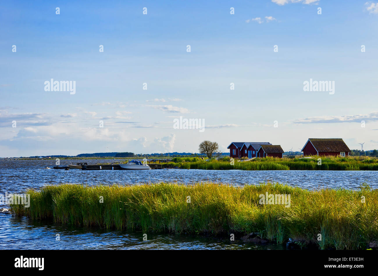 Seaside idyll in the evening light with huts and boats on the island of Oland, Sweden. Stock Photo