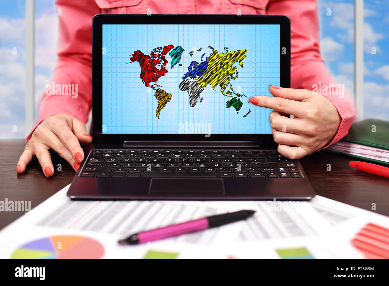 businesswoman pointing to screen laptop with world map Stock Photo