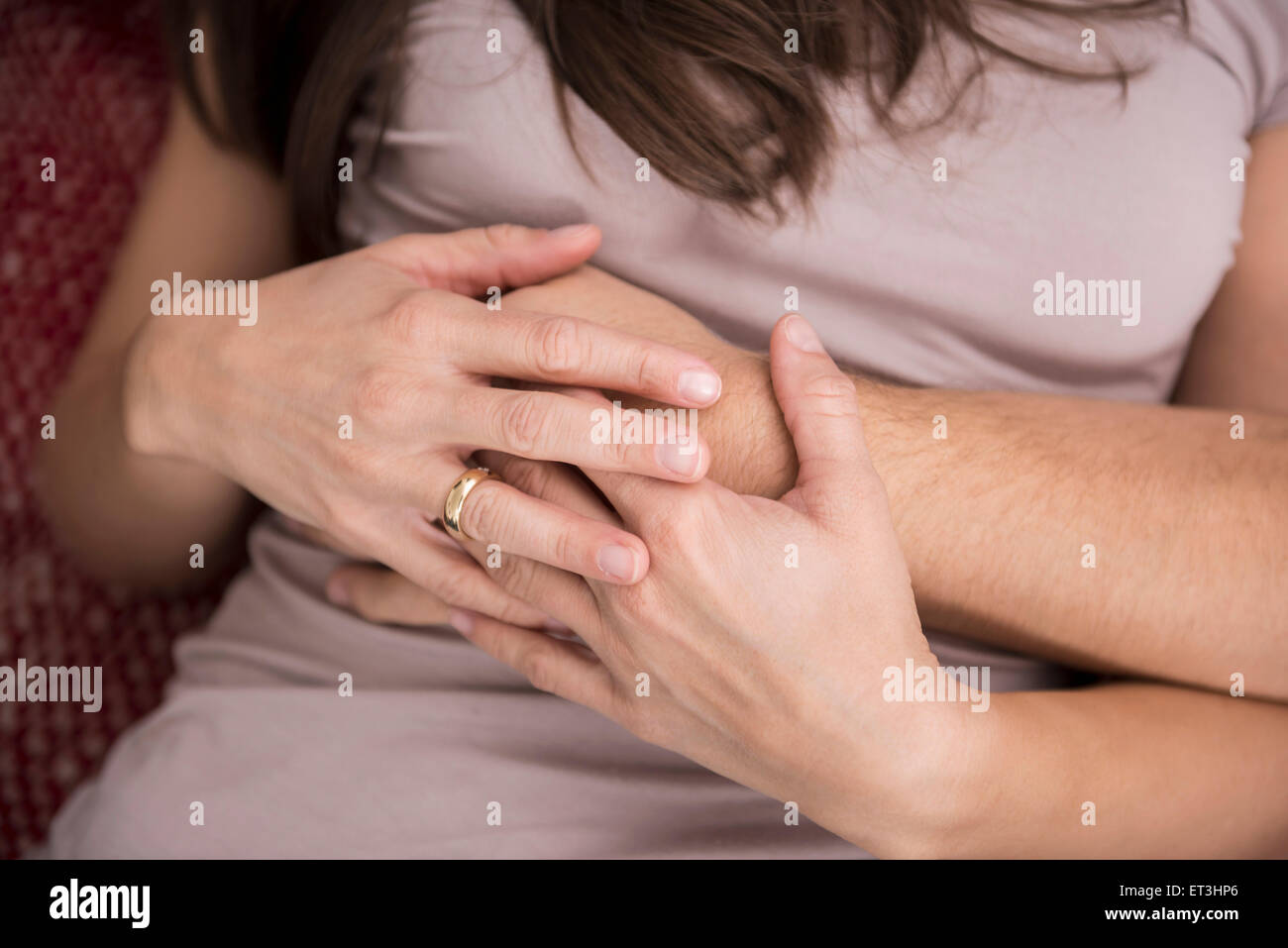Mid section view of a couple holding hands, Munich, Bavaria, Germany Stock Photo