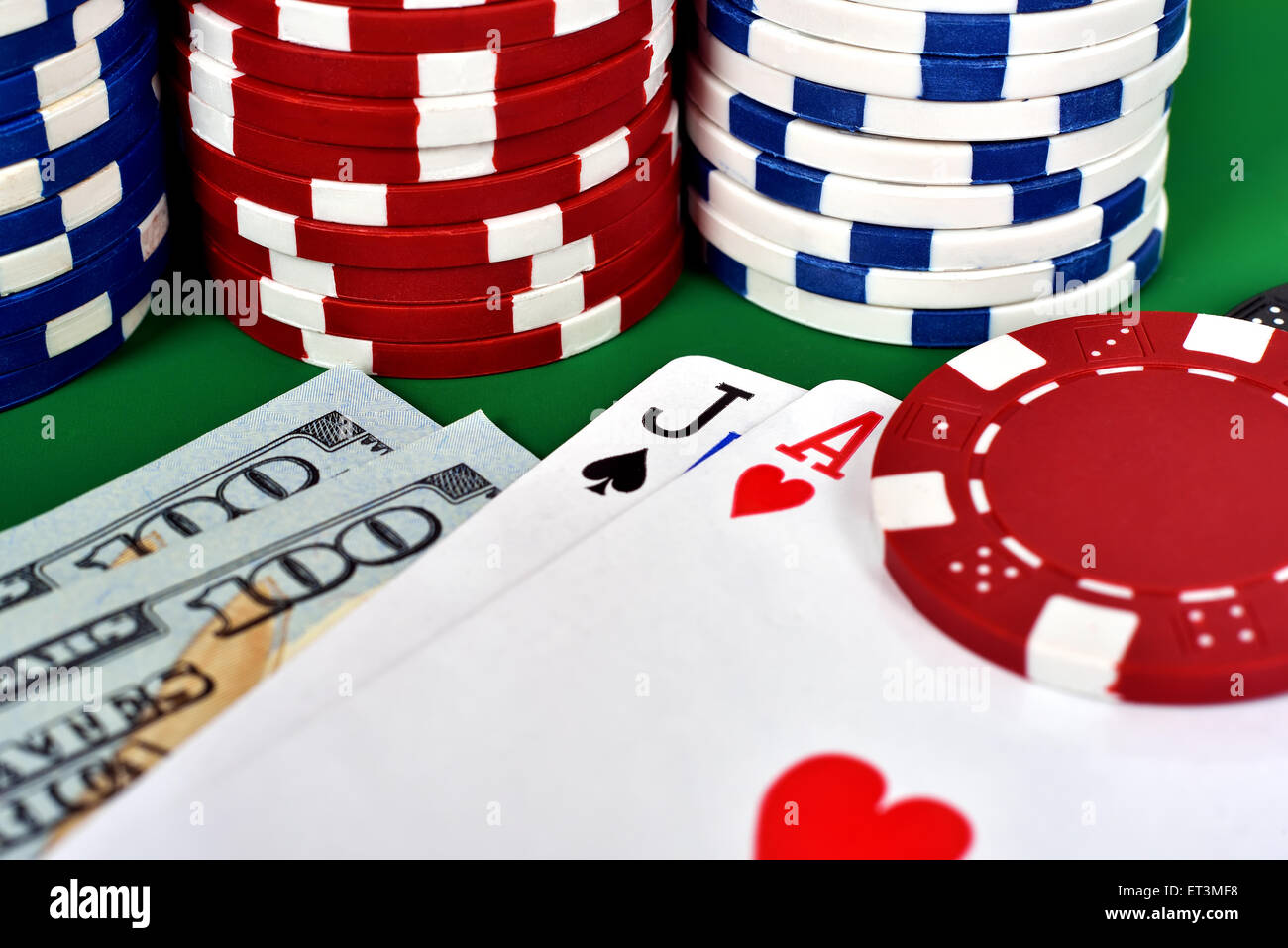 Ace, jack dollar and poker chips on table Stock Photo Alamy
