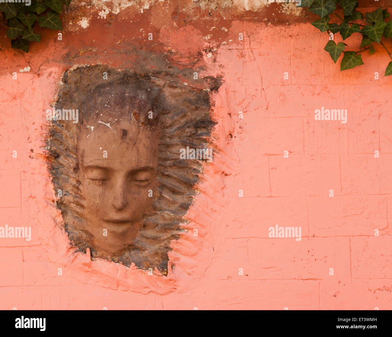 A relief of a head on the wall of the Lapin Agile, a cabaret club in Montmartre, Paris France Stock Photo