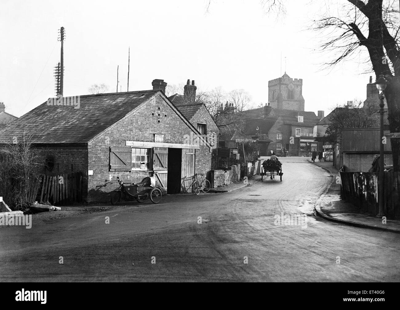 Bury Street (A4180), Ruislip, London (formerly Middlesex) old forge to be demolished and road widened. St Martins Church in the background Circa 1929 Stock Photo
