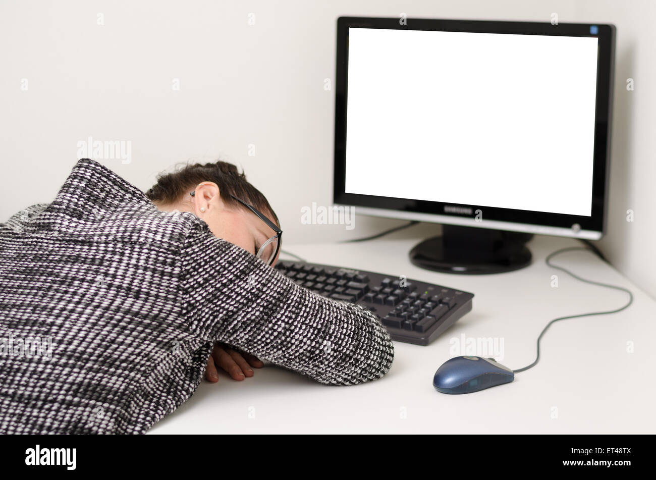 Woman Typing And Sleeping On A Computer At A Desk In The Office