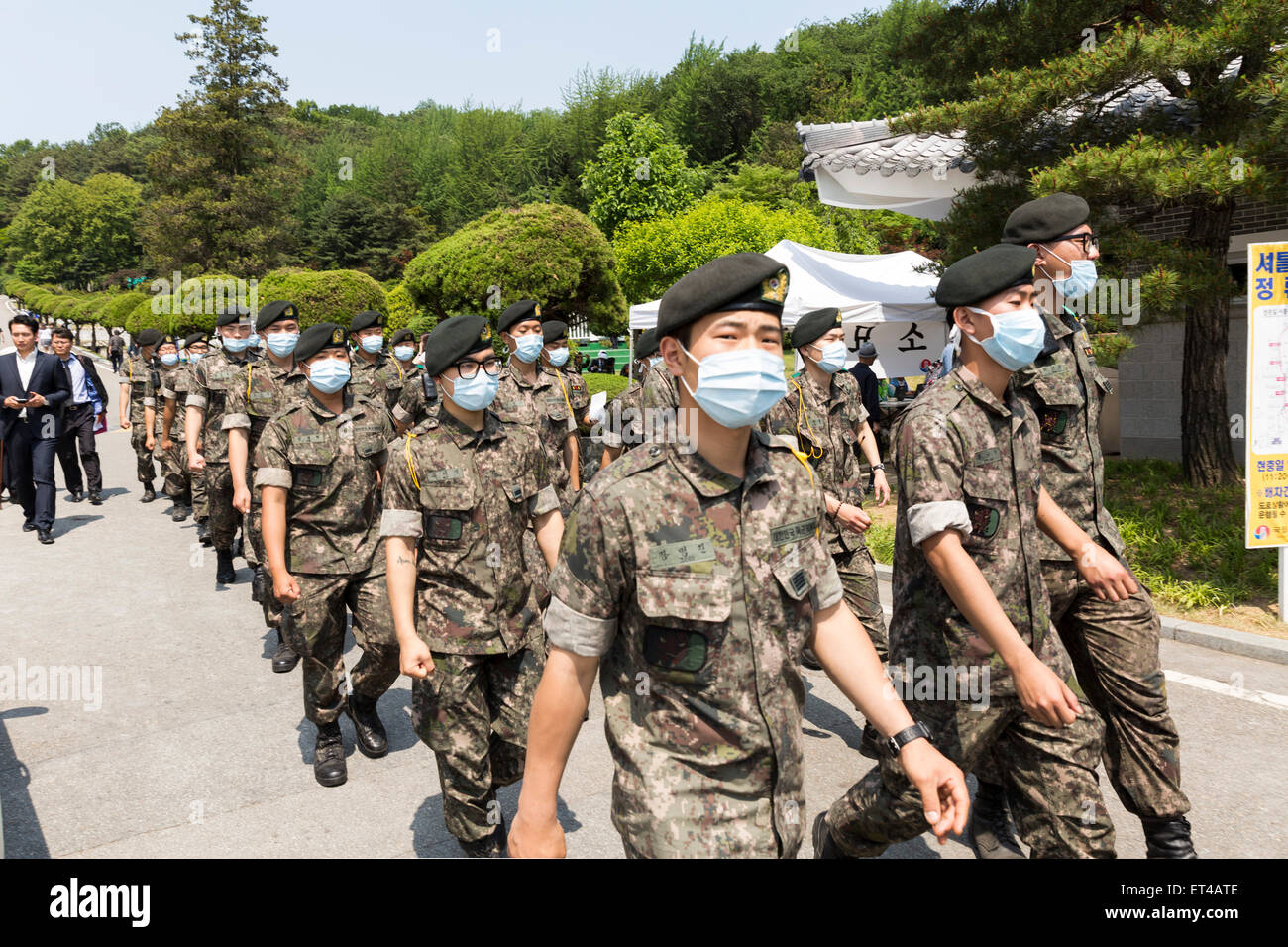 South Korean soldiers wear masks as a precaution against MERS virus during the ceremony to mark