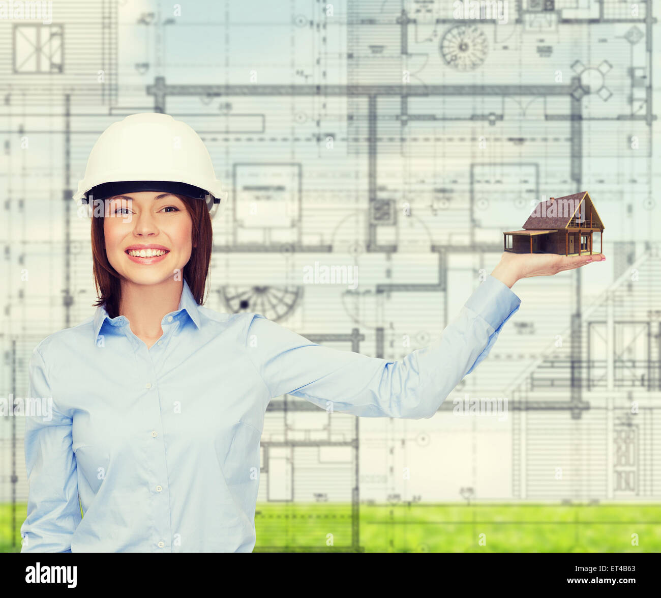 businesswoman in helmet holding house on palm Stock Photo - Alamy