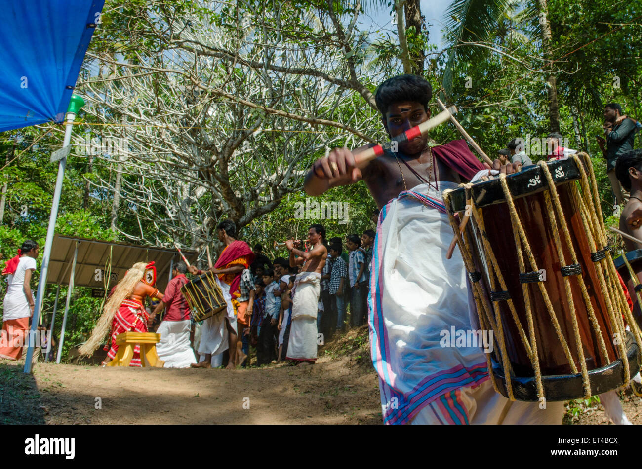 a drummer drums in the dance at the ancient tradition of Thayyam from Malabar in northern Kerrala Stock Photo