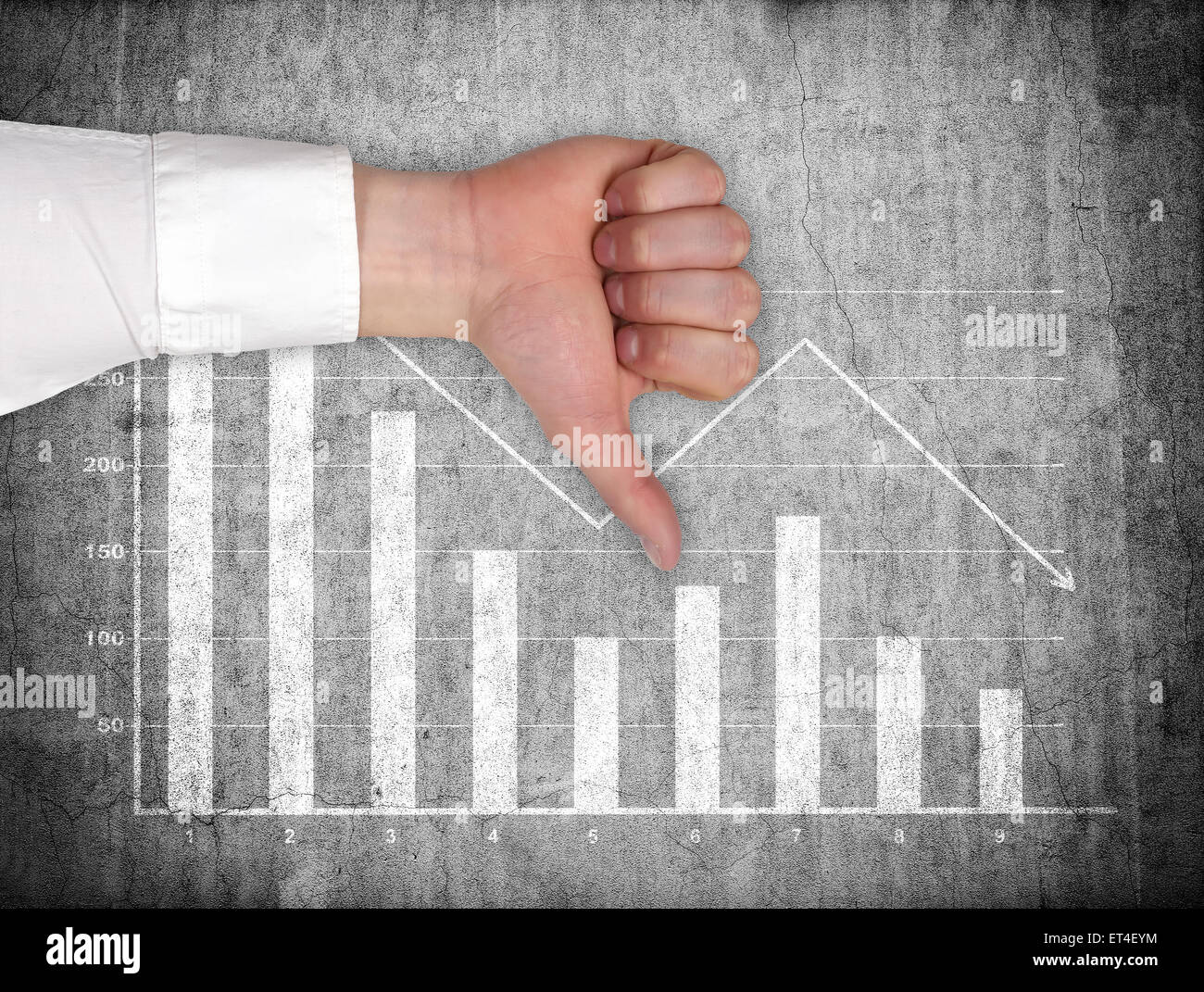 hand showing thumb down  and drawing falling chart on wall Stock Photo