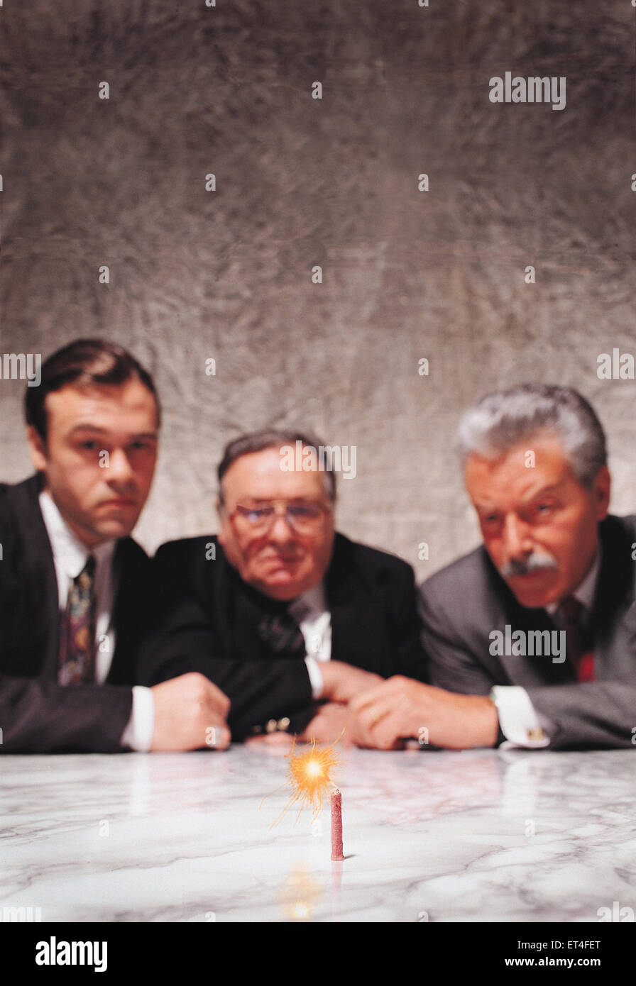 Hamburg, Germany, men watching burning fuse Stock Photo