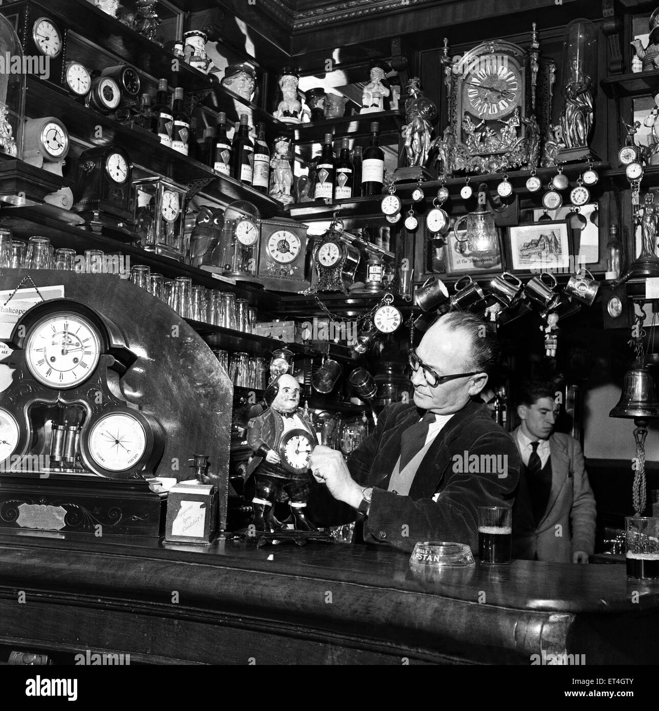 Douglas, Isle of Man. Mr J H Tulloch, the landlord of The Shakespeare Hotel and Pub is a great collector of clocks. He has about 200 standing all over the pub. 7th May 1954. Stock Photo