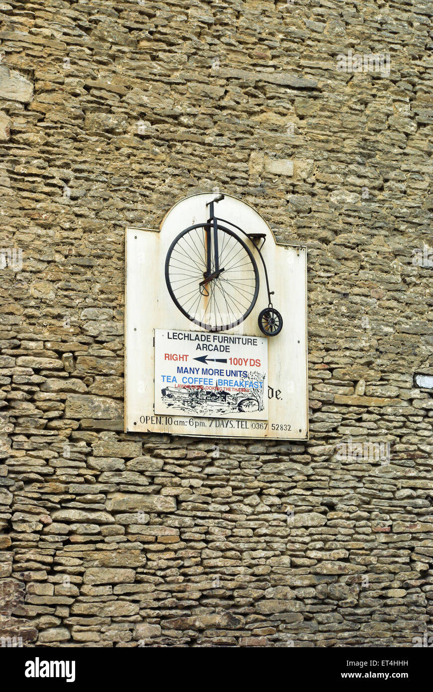 Ornate sign, featuring a metal penny farthing bicycle, advertising Lechlade Furniture Arcade, UK Stock Photo