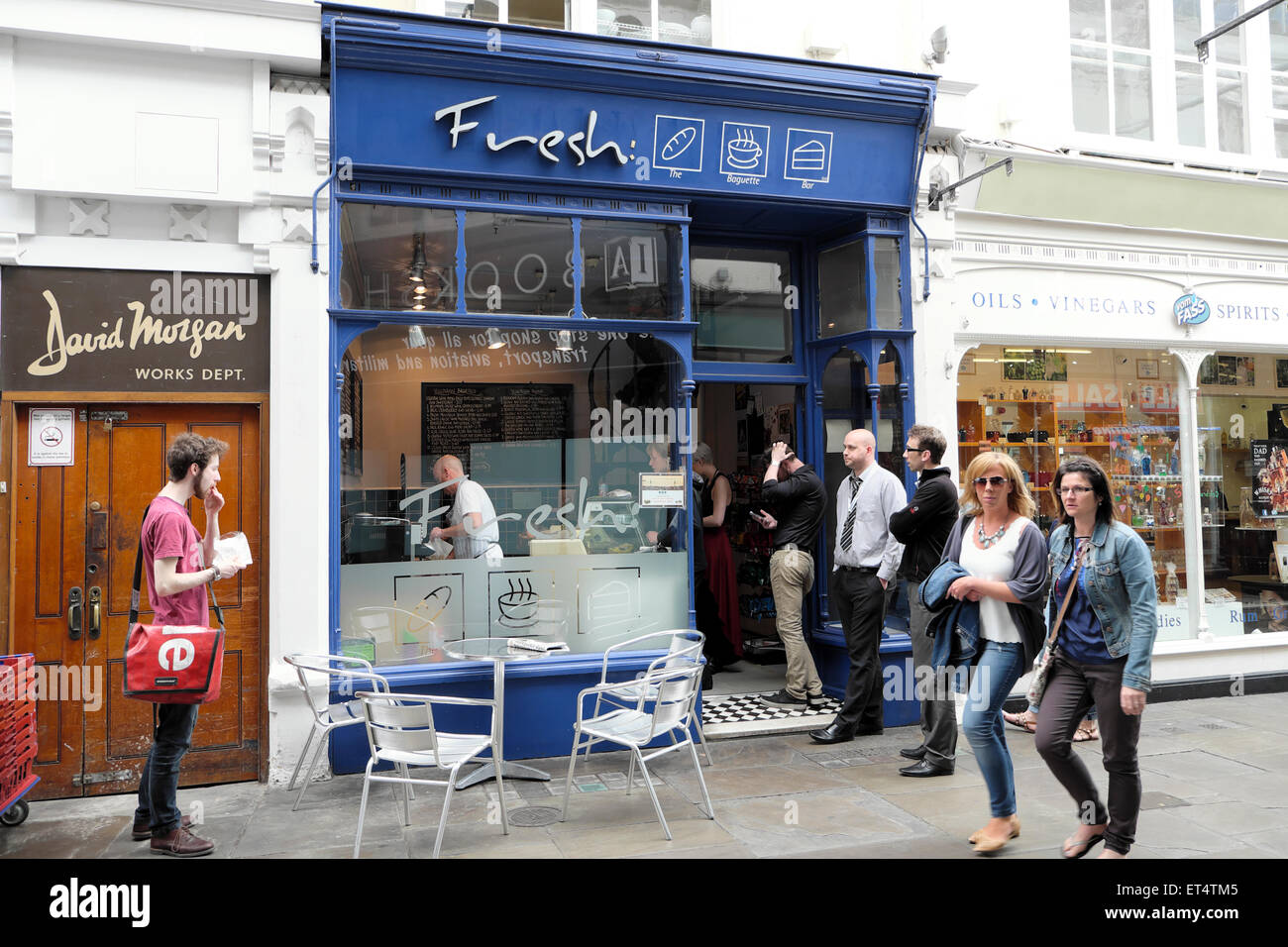 Workers queuing at Fresh sandwich shop at lunchtime for food in Royal Arcade, Cardiff City Centre, Wales UK  KATHY DEWITT Stock Photo