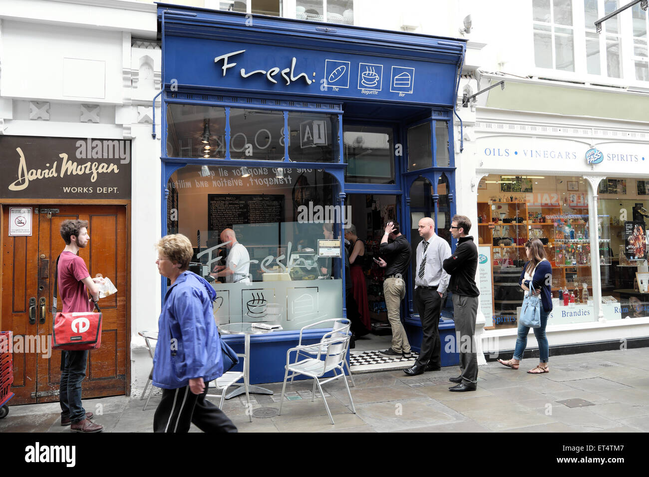 Workers queuing at Fresh sandwich shop at lunchtime for food in Royal Arcade, Cardiff City Centre, Wales UK  KATHY DEWITT Stock Photo