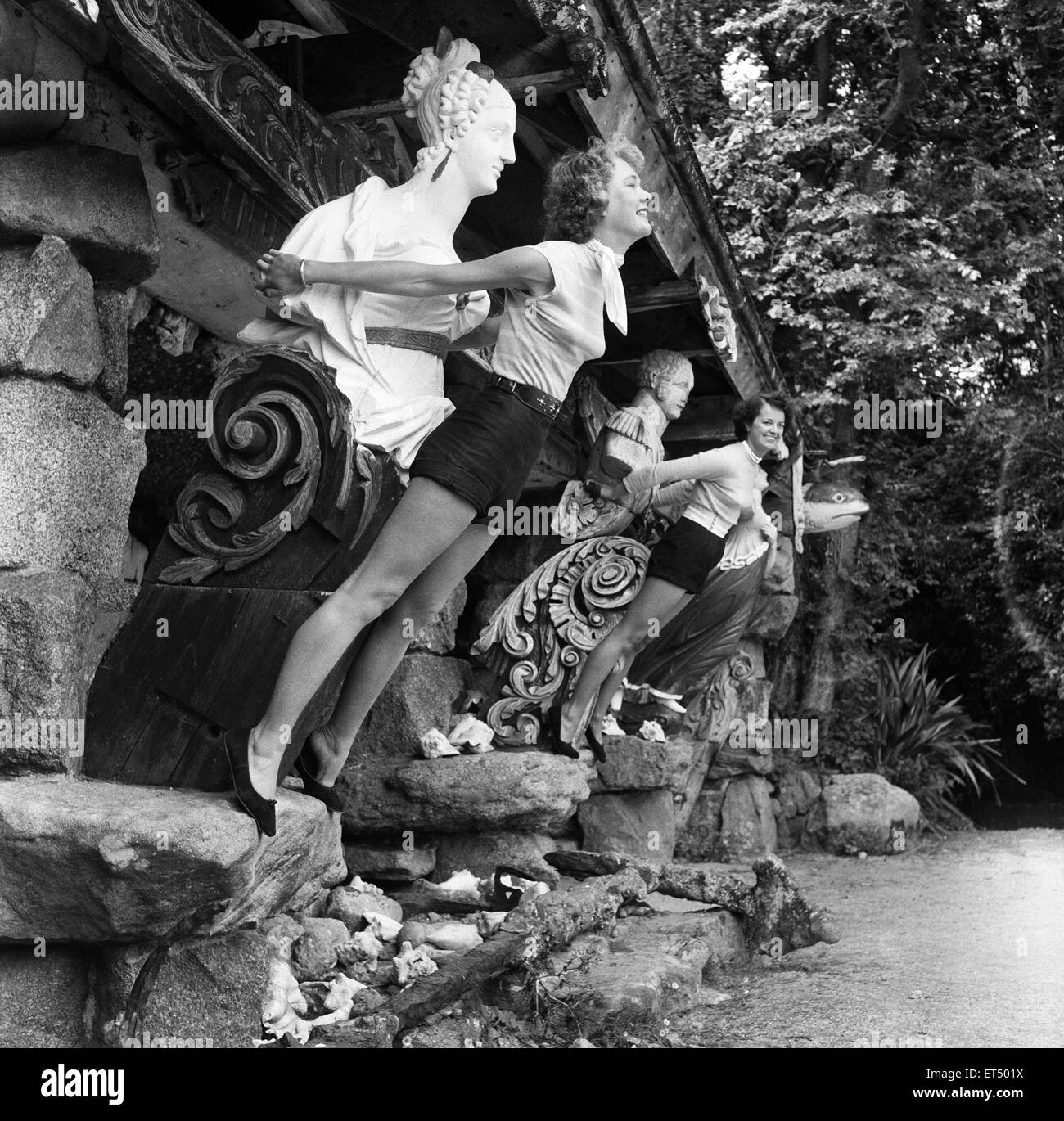Women posing at Valhalla in the Abbey Gardens in Tesco, Isles of Scilly, which contains figureheads and name-boards from ships which have been lost on the rocky coasts of the Scillies.  13th July 1954. Stock Photo
