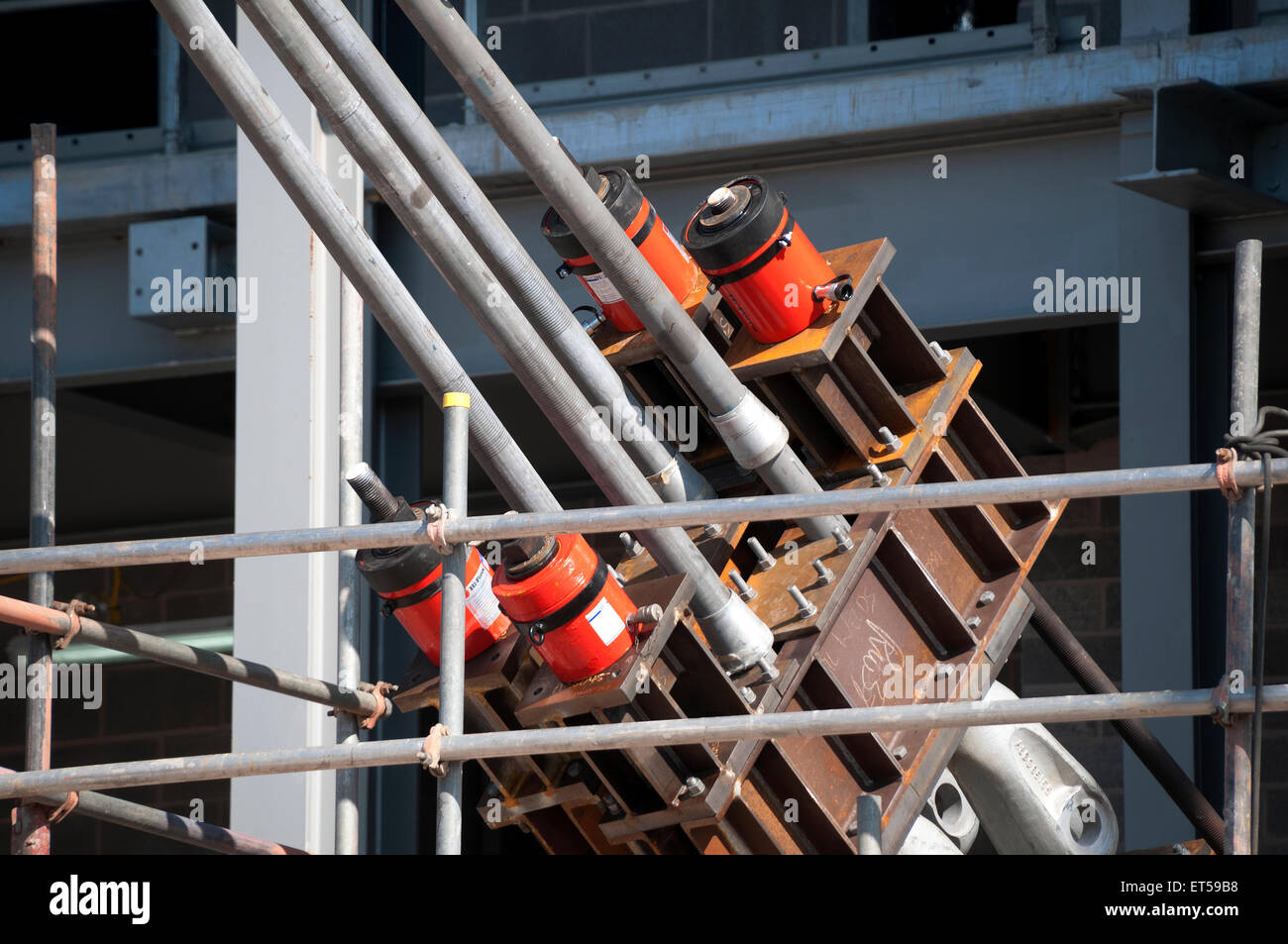 Clamps and hydraulic jacks holding the support tie ropes for the new roof, Etihad Stadium South Stand, Manchester, England, UK Stock Photo