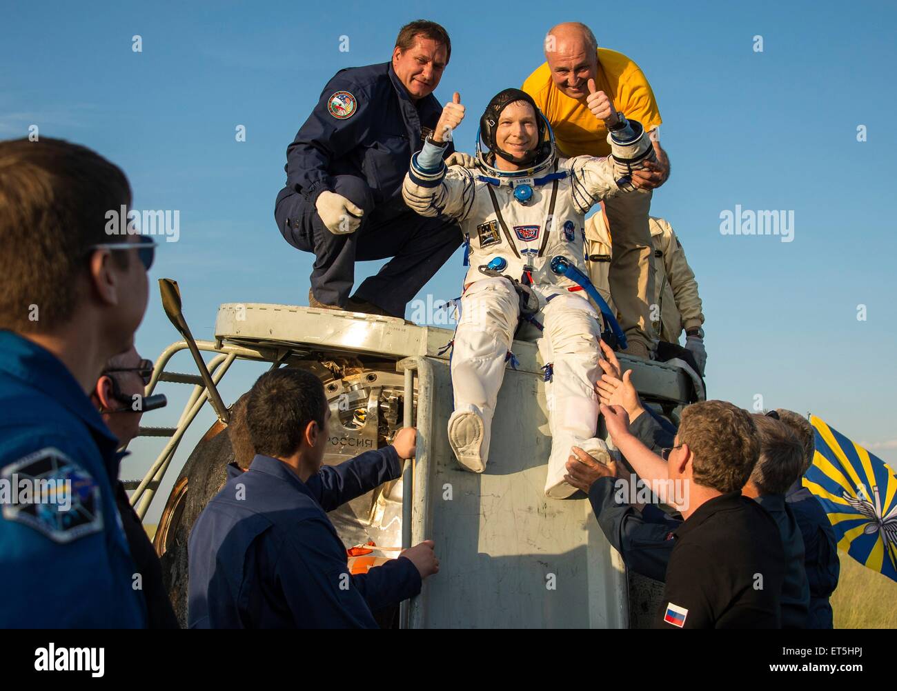 International Space Station Expedition 43 commander Terry Virts of NASA is helped out of the Soyuz TMA-15M spacecraft just minutes after he and cosmonaut Anton Shkaplerov of the Russian Federal Space Agency and Italian astronaut Samantha Cristoforetti from European Space Agency landed in a remote area June 11, 2015 near Zhezkazgan, Kazakhstan. The crew is returning after more than six months onboard the International Space Station. Stock Photo