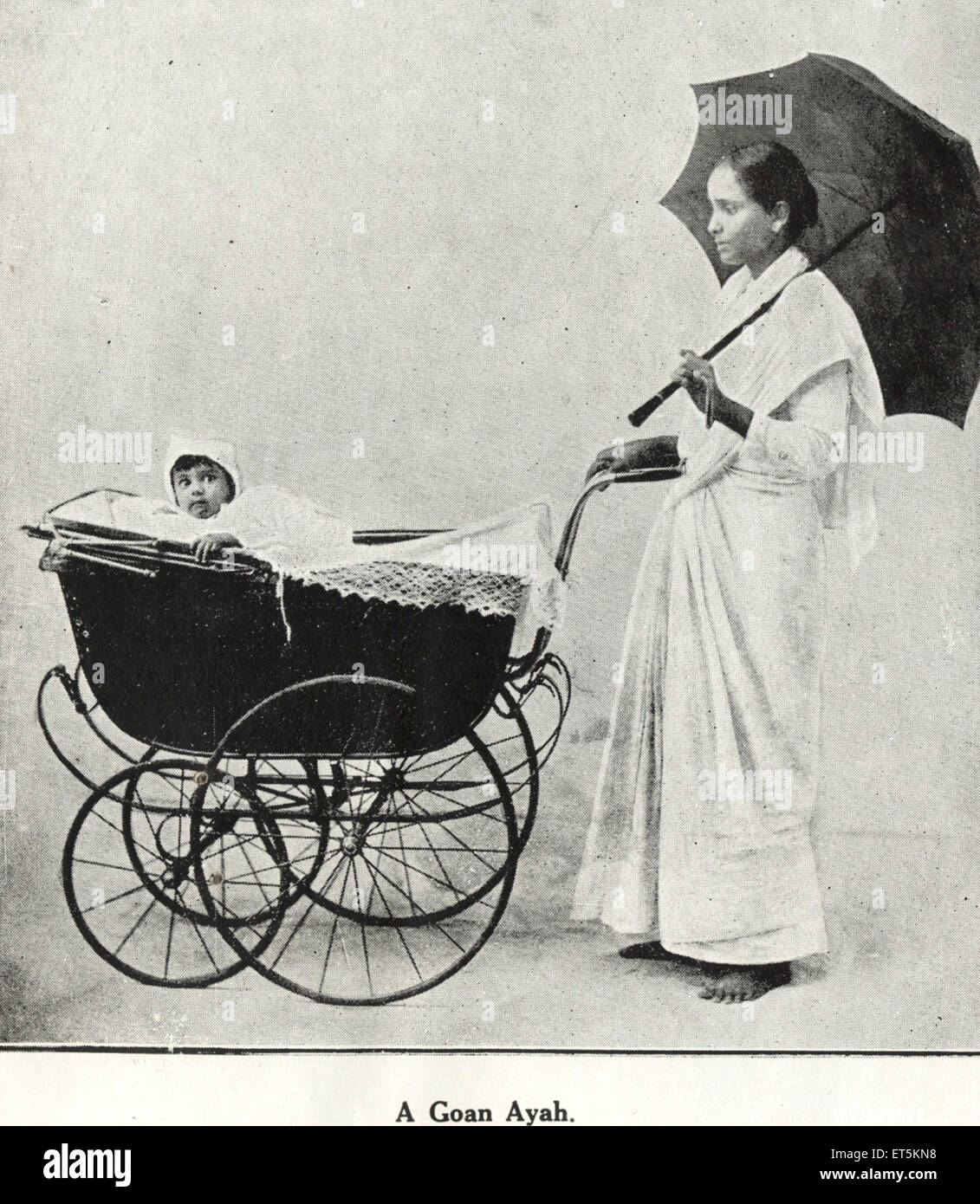 baby in pram, baby stroller, Catholic Community, aya with umbrella, India, Asia, old vintage 1800s picture Stock Photo