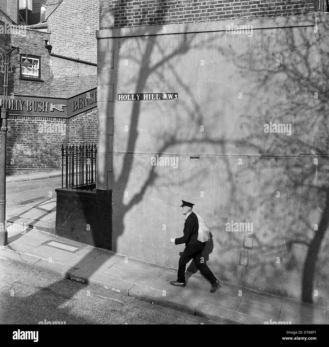 A postman walks along Holly Hill in Hampstead, North London. 8th April 1954. Stock Photo