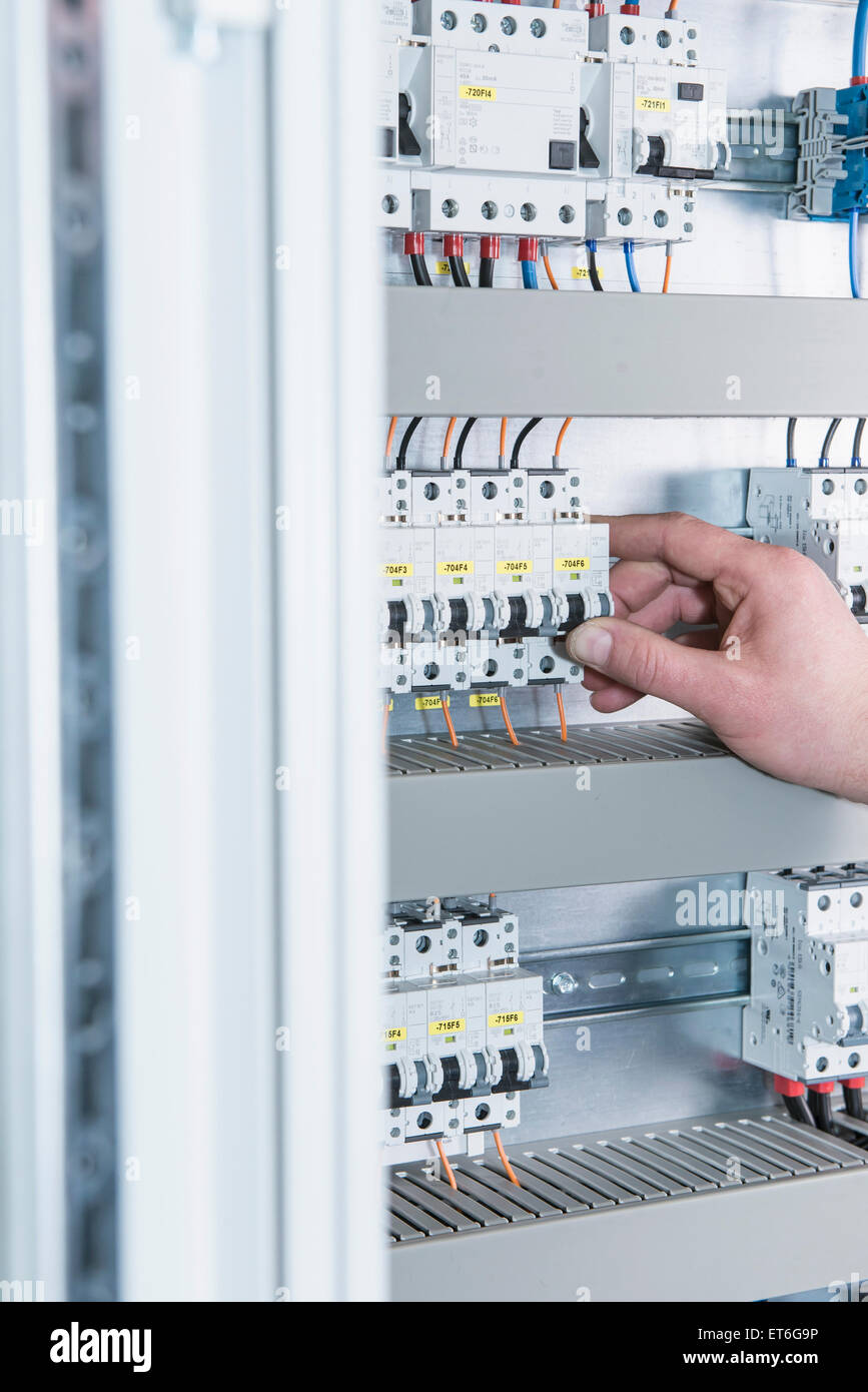 Close-up of electrician switching electrical fuse in distribution fusebox, Munich, Bavaria, Germany Stock Photo